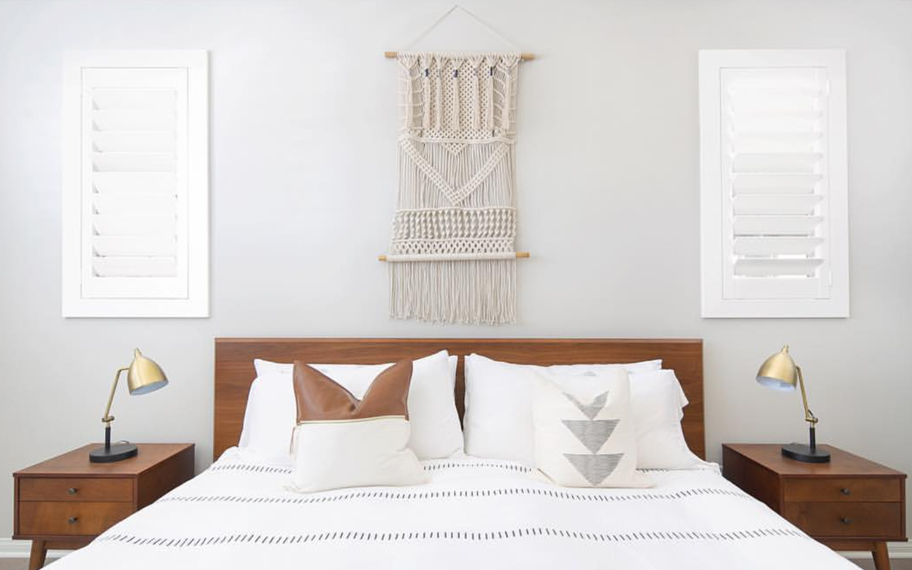 Custom-fitted louvered shutters provide excellent nighttime privacy in Riverside. Photo Credit: Audrey Crisp Louvered shutters in a bedroom.