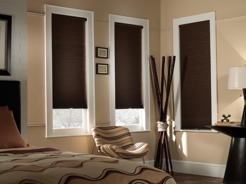 Brown roller shades in a bedroom