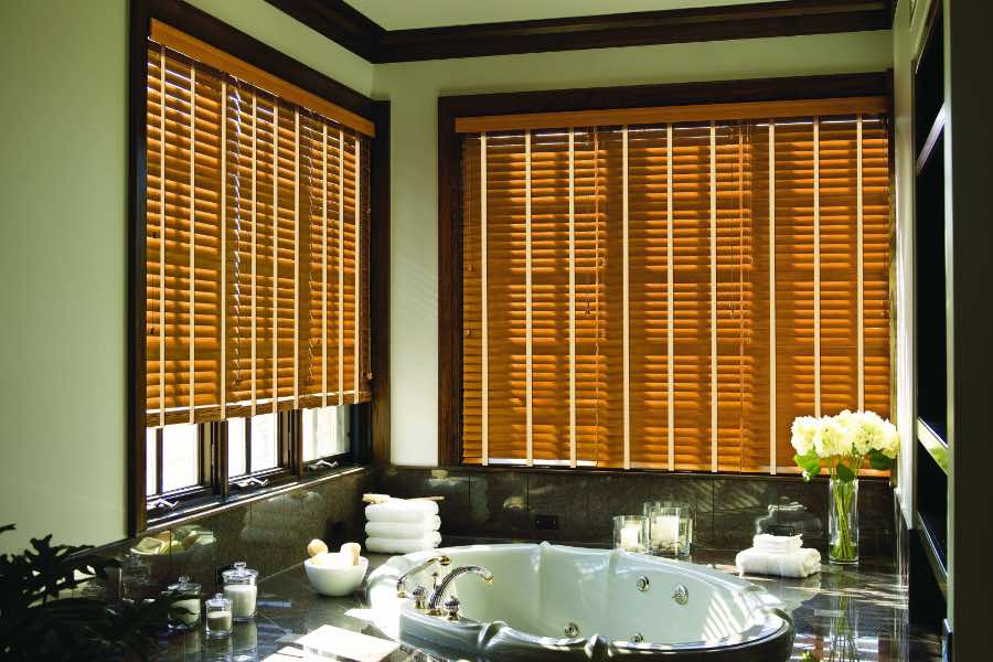 Premium quality blinds are always a stylish accent in your Riverside home. Brown wood blinds on large windows in a green bathroom