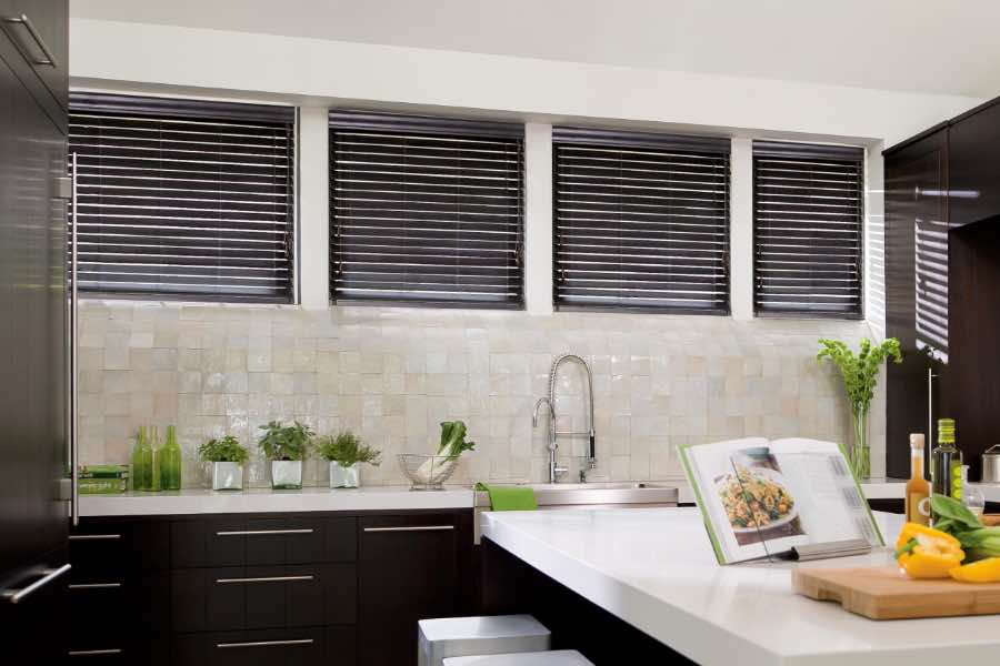 Sunburst's wood and faux wood blinds are made to look beautiful and last a long time. Black blinds on kitchen windows