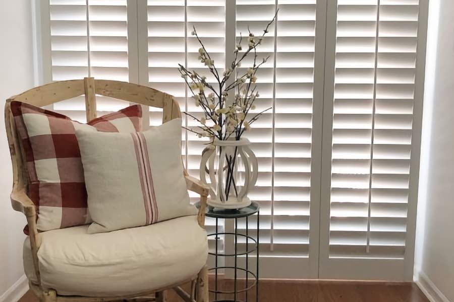 An elegant window treatment for sliding doors, plantation shutters add function and appeal to any space. White plantation shutter with adjustable louvers covering a sliding door