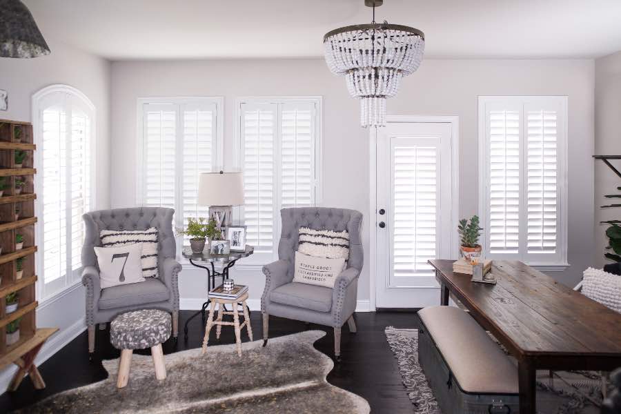 If your great room has several windows, insulate them with energy-efficient Polywood shutters. Photo Credit: Whimsy Girl Polywood shutters on multiple windows in a sitting area
