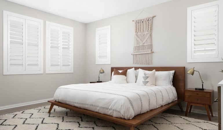 Open shutter louvers will help any Riverside room feel larger. Plantation shutters in a model home bedroom.