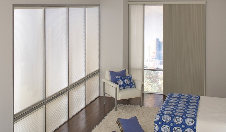 Cell shades are another choice to achieve your minimalist design. Cellular shades in a streamlined bedroom.