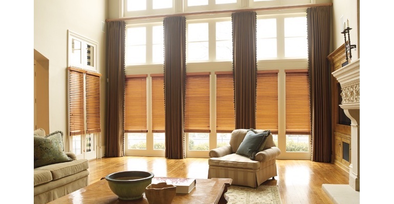 Riverside great room with wooden blinds and floor to ceiling draperies. Riverside great room with wooden blinds and floor to ceiling draperies.