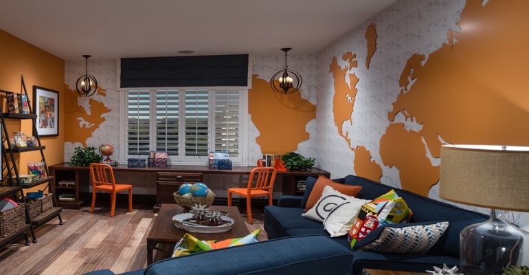 Plantation shutters are an ideal window treatment for a study area. Family room with wall map and plantation shutters