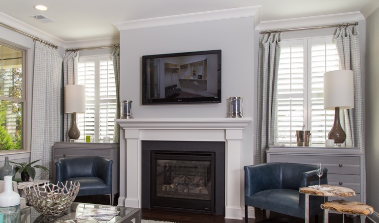 With the proper arrangements, your fireplace can run all winter long. Riverside mantle with plantation shutters.