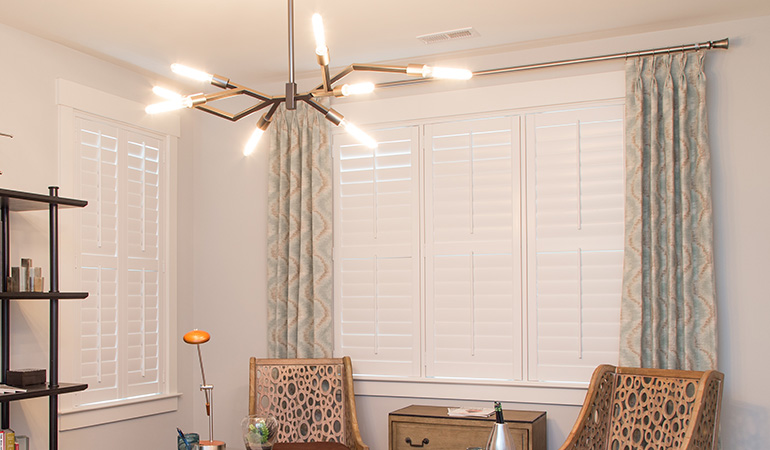 Stay warm and cozy with white Polywood shutters during the winter season. White Polywood shutters within an office