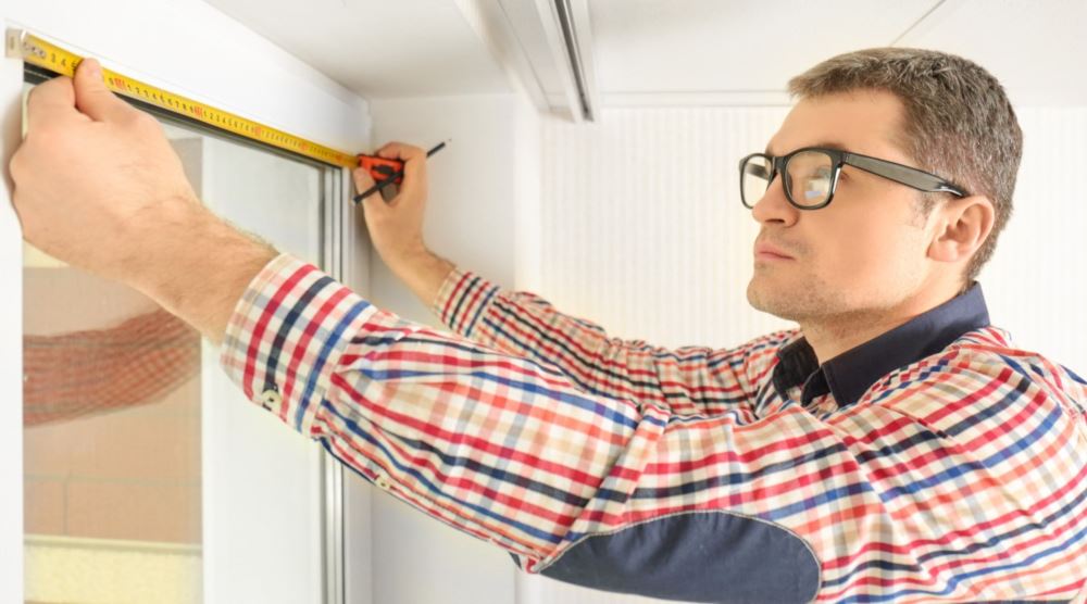 Man measuring windows in Riverside