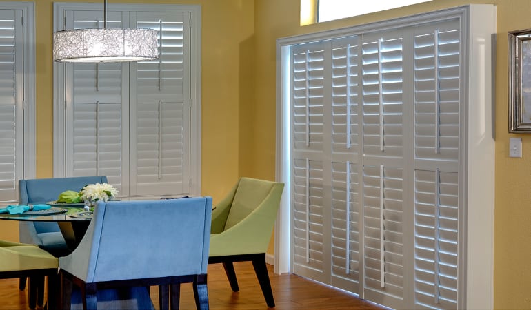 Plantation shutters on a French door function like common window shutters. Patio Doors with Plantation Shutters in Riverside