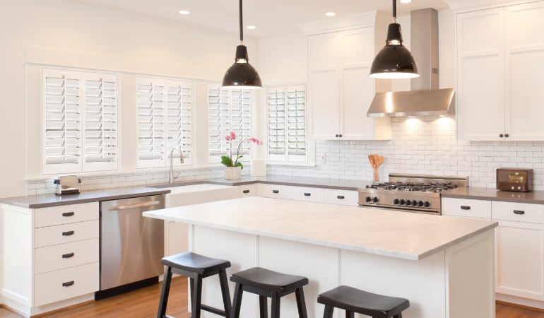 Plantation shutters let you control the amount of light in your kitchen. Plantation shutters in a bright Riverside kitchen.