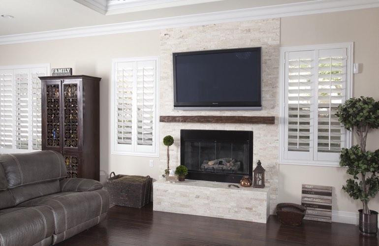 White plantation shutters in a Riverside living room with plank hardwood floors. White plantation shutters in a Riverside living room with plank hardwood floors.