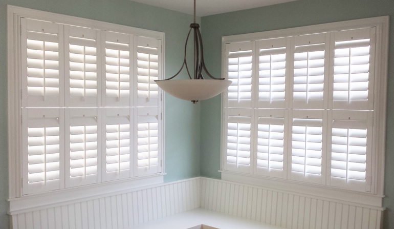 Soft green wall in Riverside kitchen with shutters.