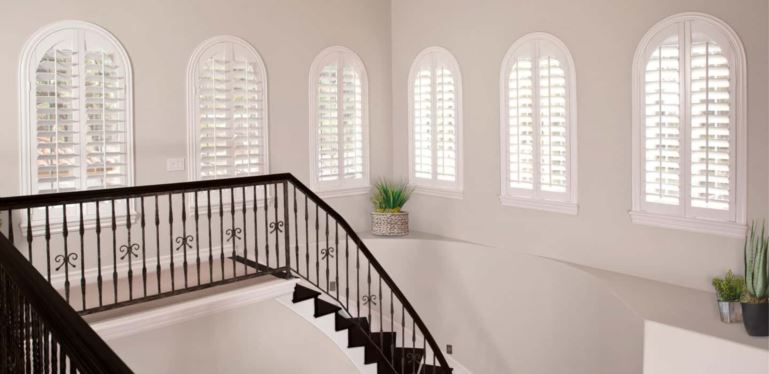 Custom-made window coverings perfectly cover your window without sticking out and catching on the trim. Arched Plantation Shutters