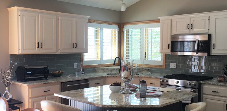Riverside kitchen with shutters and appliances