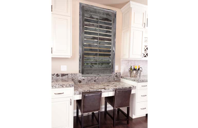 Kitchen window with reclaimed wood shutters in Riverside