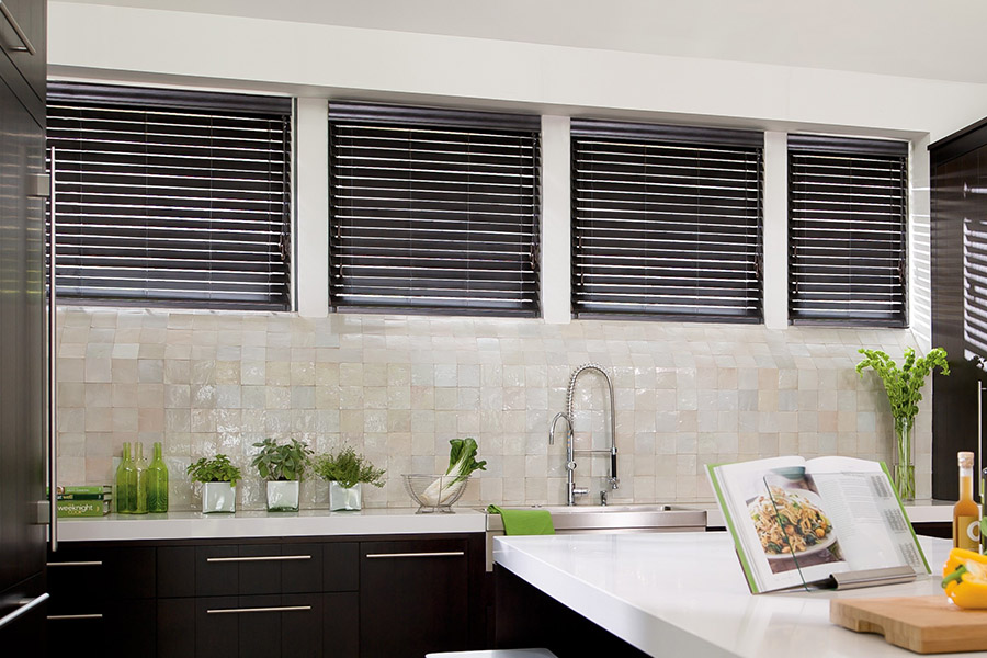 Choose custom Polywood faux wood blinds for your kitchen in Riverside. Special shaped faux wood blinds in several windows above a sink.