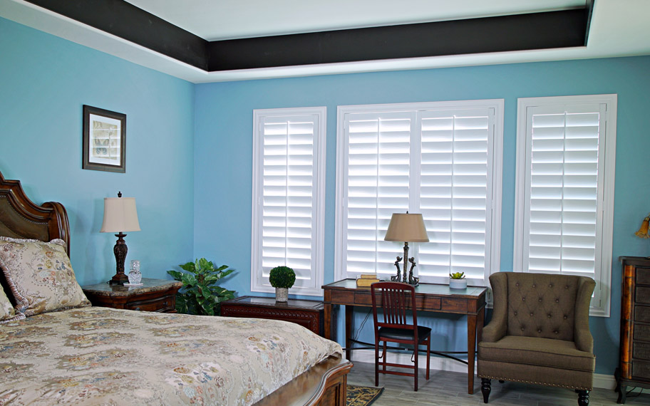 Polywood shutters provide insulation for the perfect temperature all year long in Riverside. Polywood shutters in a bedroom.