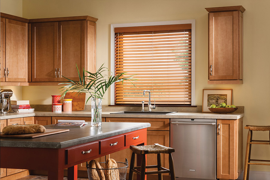 Waterproof faux wood blinds are durable and give you privacy and light control in your Riverside kitchen. Dark faux wood blinds above a kitchen sink