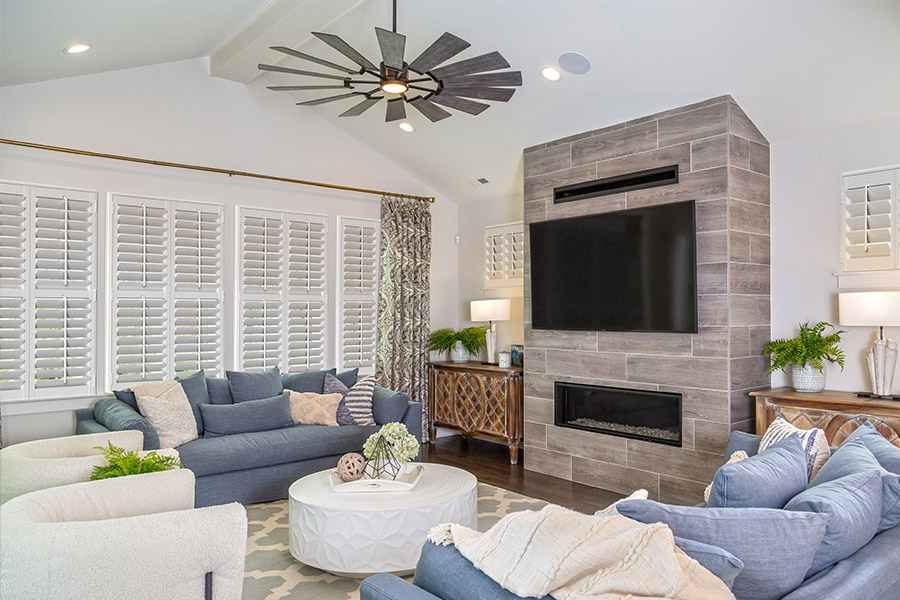 Reduce the glare on your tv screen by keeping the Polywood shutters closed. Large media room with white Polywood shutters.
