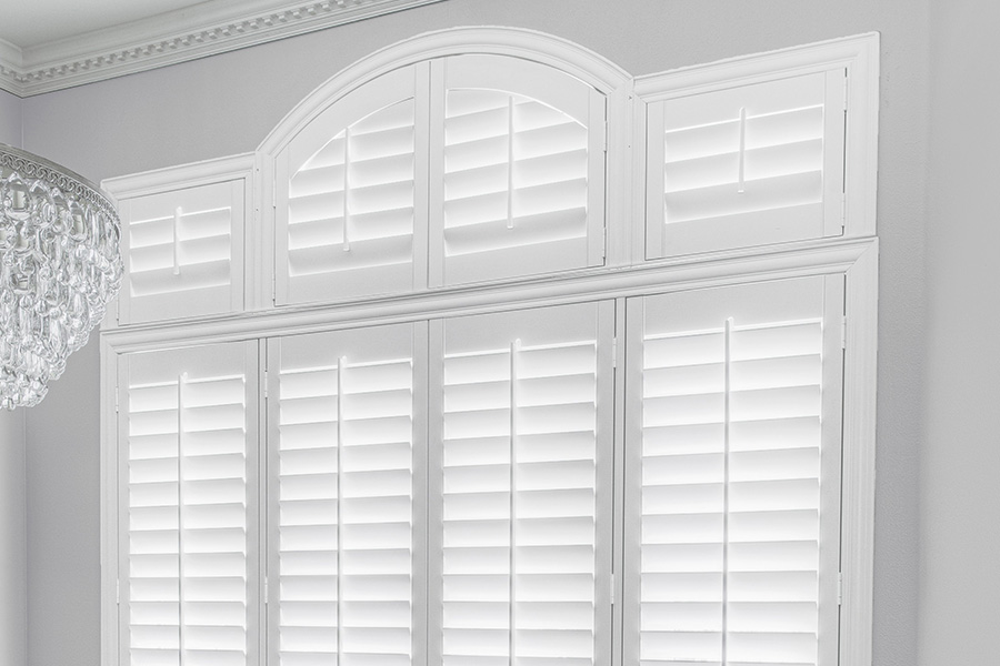 Customize your Palladian windows with white Polywood shutters in Riverside. White Polywood Palladian windows in a dining room.