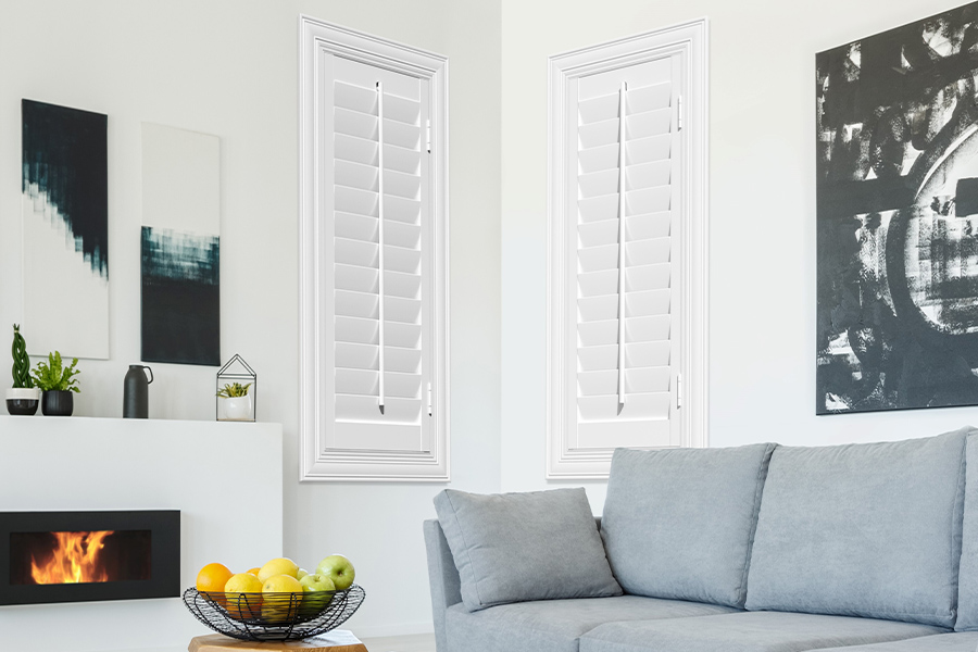 White Polywood shutters add character and class in Riverside. White polywood shutters in a corner of a modern living room.