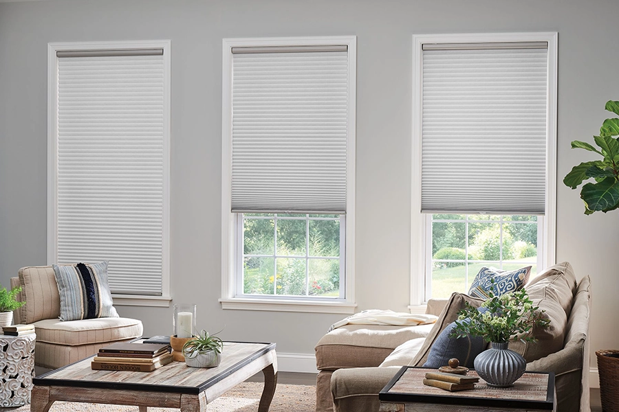 Custom cellular shades stop warm air before it heats up your house in summer. White cellular shades on living room windows