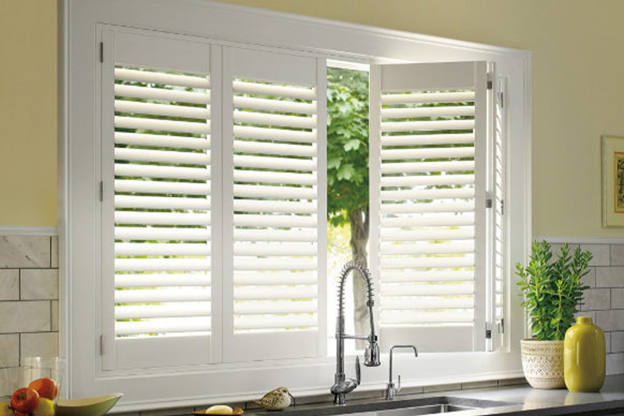 Polywood shutters are built to withstand the test of time in Riverside. White Polywood shutters above a kitchen sink.