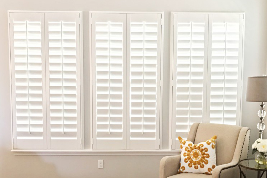 Outside-mounted interior shutters fit shallow windows and add style and energy efficiency. Outside-mounted Polywood shutters on a living room window